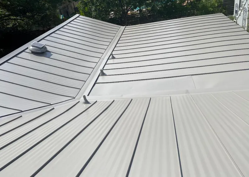 Solar attic fan installed on a metal roof for Roof Ventilation in Naples